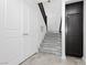 Welcoming entryway featuring tiled floors, stairwell, and storage cabinets, providing functionality at 1185 Via Dimartini, Henderson, NV 89052