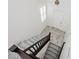 Bright entryway with tile floors, white walls, and a staircase with dark wood railing at 1185 Via Dimartini, Henderson, NV 89052
