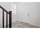 Bright entryway with tile floors, white walls, shuttered window and a white front door at 1185 Via Dimartini, Henderson, NV 89052
