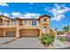 Inviting two-story townhome featuring a private garage, lovely balcony, and colorful landscaping at 1185 Via Dimartini, Henderson, NV 89052