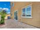 Tan two-story exterior with a brick patio and well manicured landscaping at 1185 Via Dimartini, Henderson, NV 89052