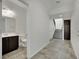 Hallway view leading to the half bath, front entrance, and stairs at 1185 Via Dimartini, Henderson, NV 89052