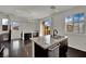 Bright, modern kitchen features stainless steel appliances, granite countertops, and dark wood flooring at 1185 Via Dimartini, Henderson, NV 89052