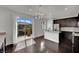 Bright, open kitchen with stainless steel appliances, dark cabinets, and a door leading to a balcony at 1185 Via Dimartini, Henderson, NV 89052