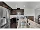 Stylish kitchen with stainless steel appliances, granite countertops, and dark wood cabinets, perfect for cooking at 1185 Via Dimartini, Henderson, NV 89052