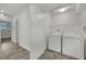 Well-lit laundry room equipped with a washer, dryer, and storage space for convenience at 1185 Via Dimartini, Henderson, NV 89052