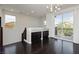 Bright living room with dark hardwood floors and sliding glass door to balcony with natural light at 1185 Via Dimartini, Henderson, NV 89052