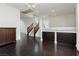 Bright living room with dark hardwood floors and stairs to upper level with natural light at 1185 Via Dimartini, Henderson, NV 89052