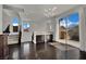 Open living space with dark wood floors, modern lighting, and access to an outdoor balcony at 1185 Via Dimartini, Henderson, NV 89052