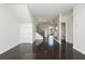 Open-concept living room with hardwood floors and white walls at 1185 Via Dimartini, Henderson, NV 89052