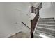 Bright stairway with neutral carpet, wooden railing, and a modern design at 1185 Via Dimartini, Henderson, NV 89052