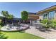 Backyard with fire pit, seating area, grill, and manicured landscaping at 12318 Tudor Arch Dr, Las Vegas, NV 89138