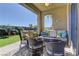 Backyard patio with lounge chairs and outdoor space with lush, green landscaping at 12318 Tudor Arch Dr, Las Vegas, NV 89138