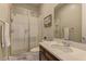 Bright bathroom with a glass shower, neutral tones, and modern single sink vanity at 12318 Tudor Arch Dr, Las Vegas, NV 89138