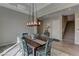 Dining room featuring wood-look flooring, a decorative ceiling, a modern chandelier, and a staircase at 12318 Tudor Arch Dr, Las Vegas, NV 89138
