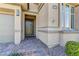 Close up of a home's entryway featuring a modern, dark-colored front door and a well-manicured stone pathway at 12318 Tudor Arch Dr, Las Vegas, NV 89138
