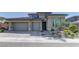 Charming single-story home featuring a three-car garage, beautiful landscaping, and a welcoming entrance at 12318 Tudor Arch Dr, Las Vegas, NV 89138