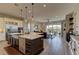 Spacious kitchen with white quartz countertops, stainless steel appliances, and an oversized island at 12318 Tudor Arch Dr, Las Vegas, NV 89138