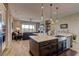 Bright and airy kitchen featuring a large island with seating and a view into the living room at 12318 Tudor Arch Dr, Las Vegas, NV 89138