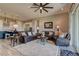 Spacious living room featuring a ceiling fan and sliding glass door to the backyard at 12318 Tudor Arch Dr, Las Vegas, NV 89138