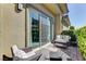 Outdoor patio space with seating area, sliding glass door access, and beautiful landscaping at 12318 Tudor Arch Dr, Las Vegas, NV 89138