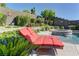 Inviting lounge chair and view of the pool area surrounded by mature landscaping at 12318 Tudor Arch Dr, Las Vegas, NV 89138