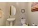 Elegant powder room with pedestal sink and a decorative mirror, creating a stylish and functional space at 12318 Tudor Arch Dr, Las Vegas, NV 89138