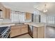 Functional kitchen featuring stainless steel appliances, light wood cabinetry, and backyard views at 1356 Pleasant Brook St, Las Vegas, NV 89142