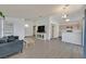 Open concept living space with a kitchen view, wood-look floors, and neutral color palette at 1356 Pleasant Brook St, Las Vegas, NV 89142