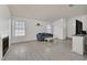 Inviting living room with wood-look floors, a cozy fireplace, and bright, natural light at 1356 Pleasant Brook St, Las Vegas, NV 89142