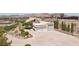 Aerial view of a hilltop home with a spacious driveway and an attached three-car garage at 1409 Pueblo Dr, Boulder City, NV 89005