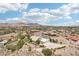 Aerial view showcasing a beautiful home, mature landscaping, and views of the city at 1409 Pueblo Dr, Boulder City, NV 89005