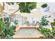 Relaxing indoor atrium featuring a small pool, lush plants, and glass doors for natural light at 1409 Pueblo Dr, Boulder City, NV 89005
