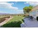 Lush backyard features manicured lawns, mature trees, and outdoor seating area for relaxing and entertaining at 1409 Pueblo Dr, Boulder City, NV 89005