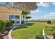 Expansive backyard features a meticulously maintained lawn, lush landscaping, and mature trees for privacy at 1409 Pueblo Dr, Boulder City, NV 89005