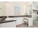 Bright bathroom vanity with illuminated mirror and glass block window at 1409 Pueblo Dr, Boulder City, NV 89005