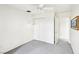 This is a bedroom with neutral carpet, a ceiling fan, and a double closet with white doors at 1409 Pueblo Dr, Boulder City, NV 89005