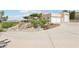 Exterior view featuring the home on a hillside, xeriscaping, and an extended driveway at 1409 Pueblo Dr, Boulder City, NV 89005