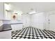 Spacious garage featuring checkerboard flooring, ample storage cabinets, and a utility sink for convenience at 1409 Pueblo Dr, Boulder City, NV 89005