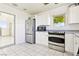 Clean kitchen featuring stainless steel appliances, white cabinets, and bright tile floors at 1409 Pueblo Dr, Boulder City, NV 89005