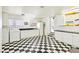 Spacious laundry room with checkerboard floors and plenty of cabinet space at 1409 Pueblo Dr, Boulder City, NV 89005