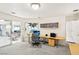 Bright office space featuring a large window, custom storage cabinets and a door leading to the patio at 1409 Pueblo Dr, Boulder City, NV 89005