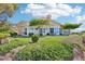 Expansive backyard featuring lush greenery and a charming home with large windows at 1409 Pueblo Dr, Boulder City, NV 89005