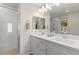 Well-lit bathroom featuring a double sink vanity, stylish mirrors, and a glass enclosed shower at 145 Harmonica Ave # Lot 23, Henderson, NV 89015