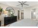 Bright bedroom features a ceiling fan, ensuite bath, walk-in closet and stylish black dresser at 145 Harmonica Ave # Lot 23, Henderson, NV 89015