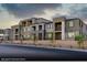 Modern townhome exterior featuring multiple balconies and well manicured landscaping with a stone facade on the entryway at 145 Harmonica Ave # Lot 23, Henderson, NV 89015
