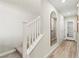 Hallway featuring the stairway, a decorative mirror, and direct access to the garage from inside the home at 145 Harmonica Ave # Lot 23, Henderson, NV 89015