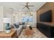 Cozy living room with a plush sectional sofa, modern decor, a ceiling fan, and a decorative wooden accent wall at 145 Harmonica Ave # Lot 23, Henderson, NV 89015