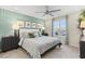 Bright and modern main bedroom showcasing a ceiling fan, a light accent wall, and lots of natural light at 145 Harmonica Ave # Lot 23, Henderson, NV 89015