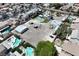 Wide aerial shot of the property featuring a pool, extra buildings, and vehicle parking at 1595 E Camero Ave, Las Vegas, NV 89123